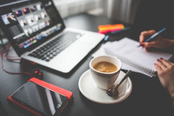  A person typing on a laptop keyboard with a title "How to Write a Blog Post" on the screen.
